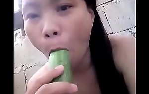 Oriental masturbating with cucumber